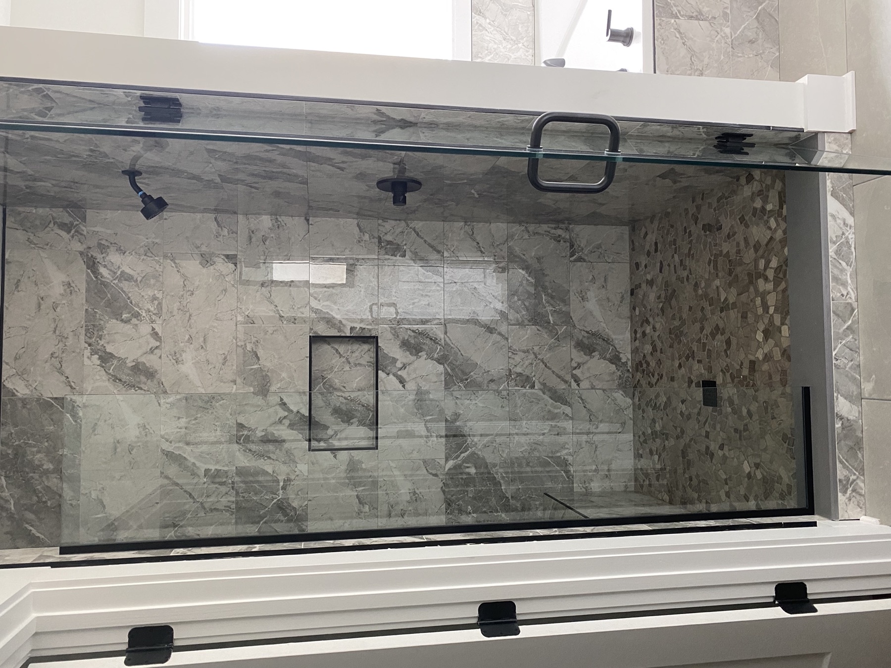 Walk-in shower · marble walls & pebble floor