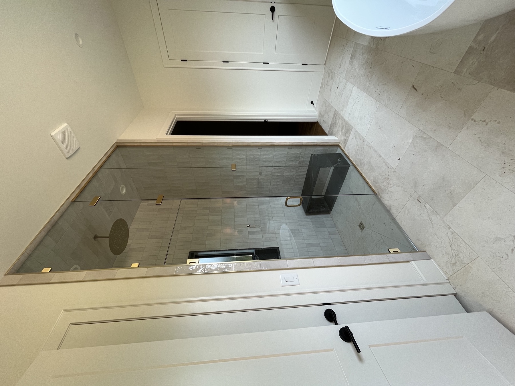 Glass shower · vertical tile & gold hardware